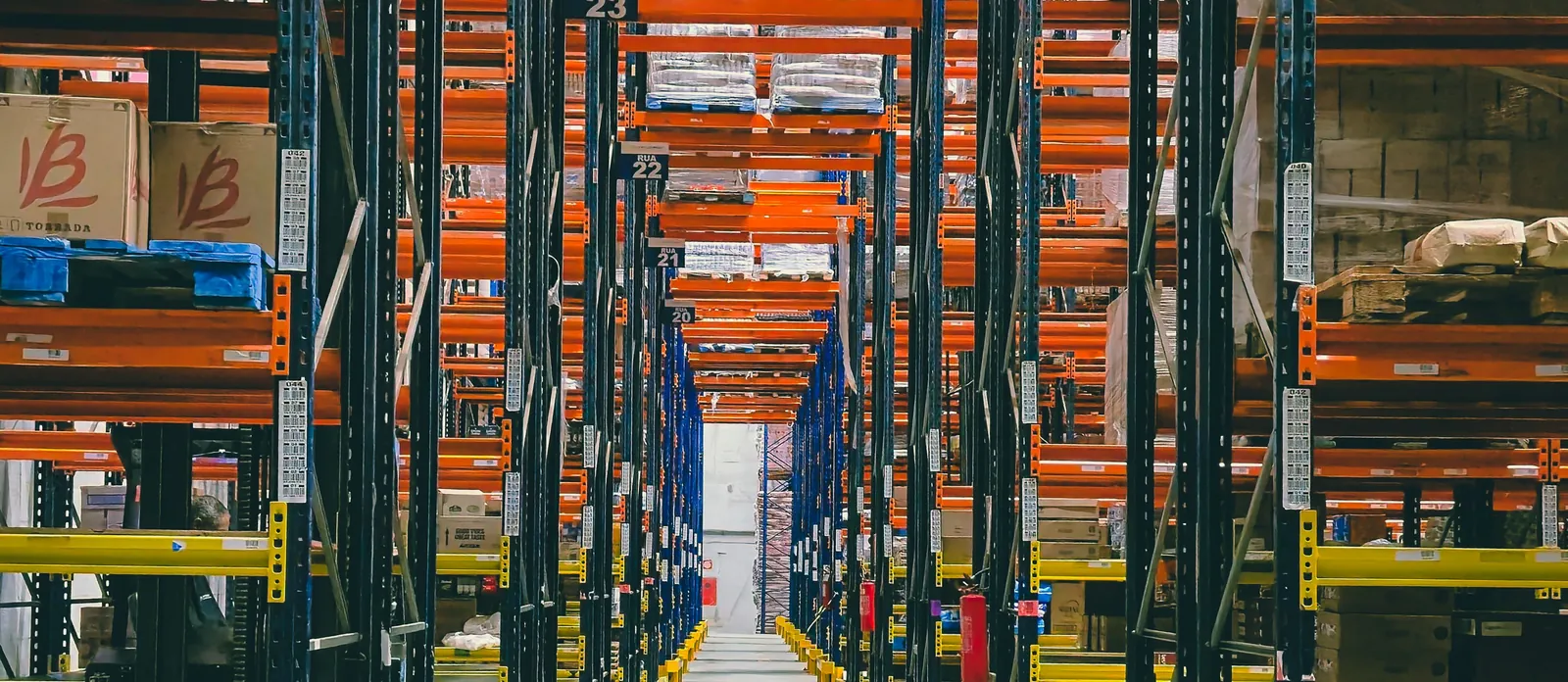 Long aisle between tall warehouse racking at Aerologix Global